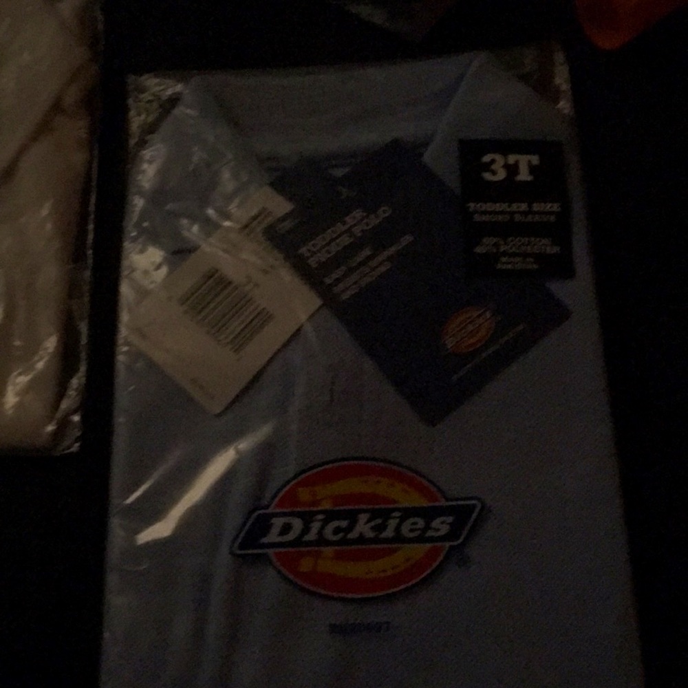 Two new 3T Polo style shirts, one blue, one white still in packaging with tags.